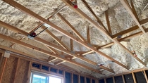 Image of an overhead ceiling cavity with BASF Open-cell SPray Polyurethane Foam installed