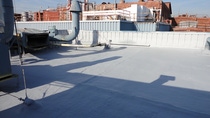 Image of a commercial roof with BASF Spray Polyurethane Foam instaleld with a Silicone Coating