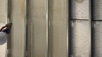 Close up of our WALLTITE BASF Closed-cell SPray Polyurethane Foam being sprayed into a commercial building wall with metal framing