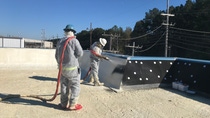 Image of two contractors installing SKYTITE BASF Spray Polyurethane Foam in a commercial roof