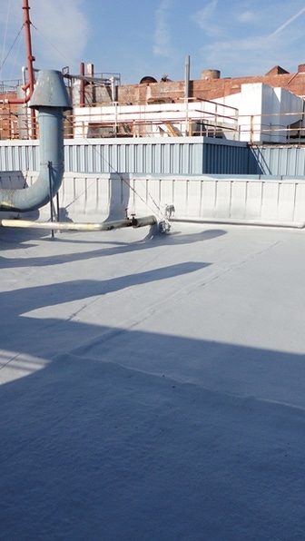 Image of a commercial roof with BASF Spray Polyurethane Foam instaleld with a Silicone Coating