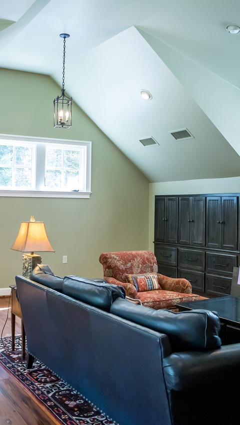Image of a fully finished and furnished bonus room above a garage