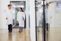 Two Scientists walking through a lab