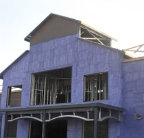WALLTITE® purple spray foam applied to the exterior wall of a commercial building